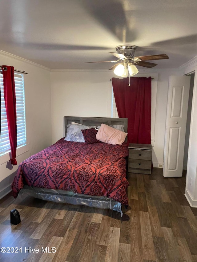 bedroom with ceiling fan, crown molding, and dark hardwood / wood-style floors