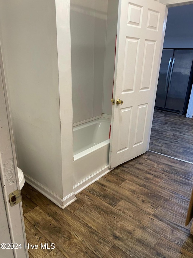 bathroom with toilet and hardwood / wood-style flooring
