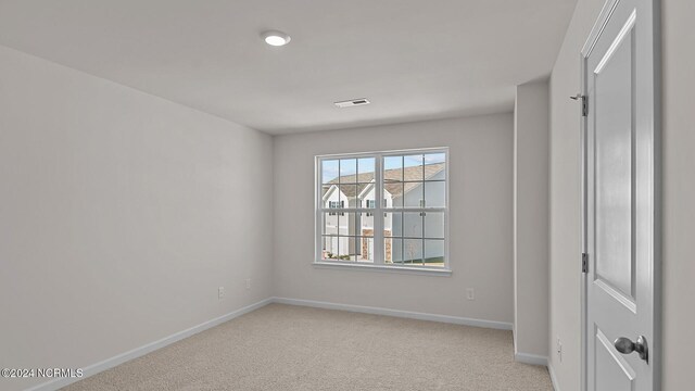 empty room with light colored carpet