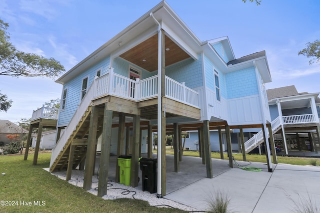 rear view of house with a carport and a lawn