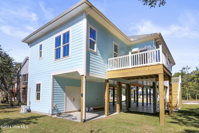 back of house featuring a yard, a patio, and a deck