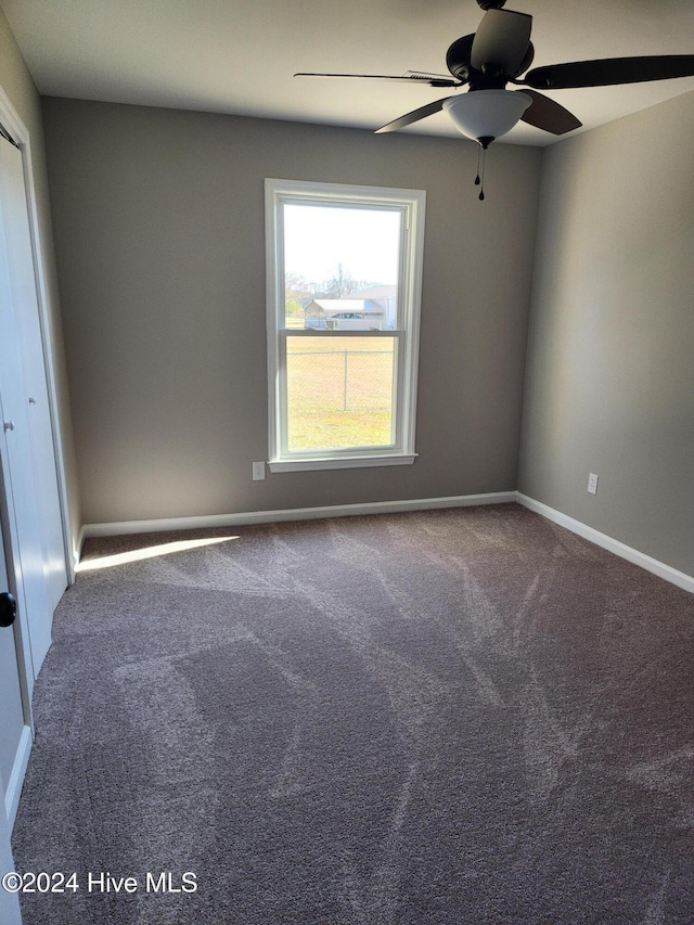 spare room featuring carpet floors and ceiling fan