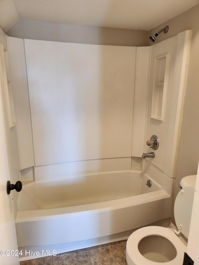 bathroom with washtub / shower combination and toilet