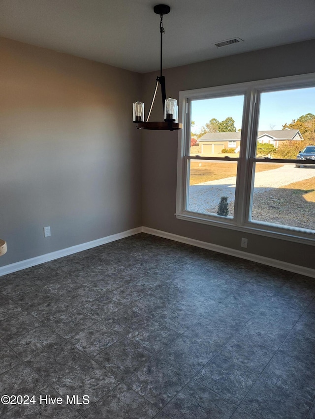 unfurnished dining area with an inviting chandelier