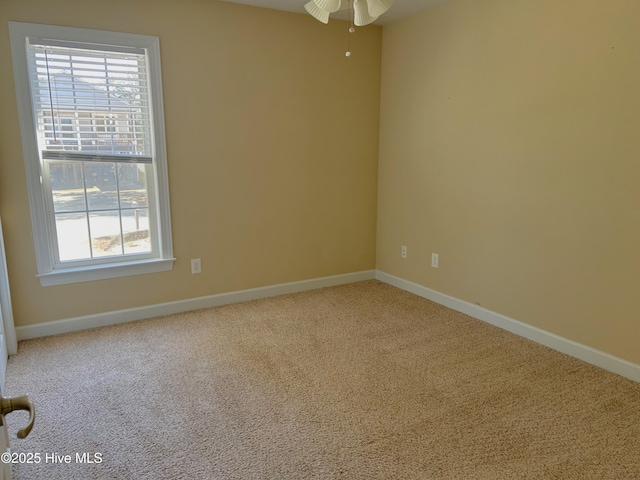 carpeted empty room featuring ceiling fan