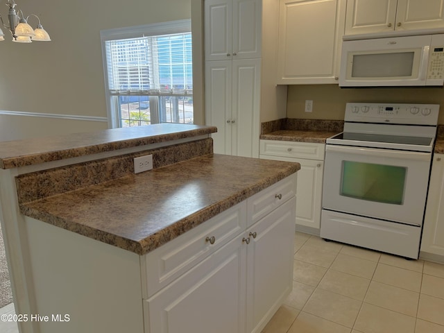 kitchen featuring light tile patterned flooring, white cabinetry, hanging light fixtures, a center island, and white appliances