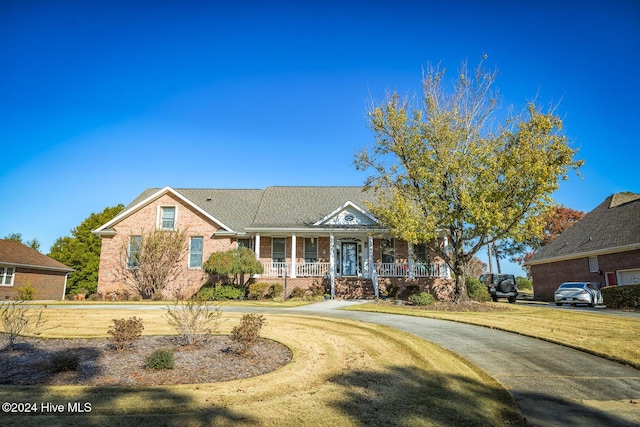 view of front of property with covered porch and a front lawn