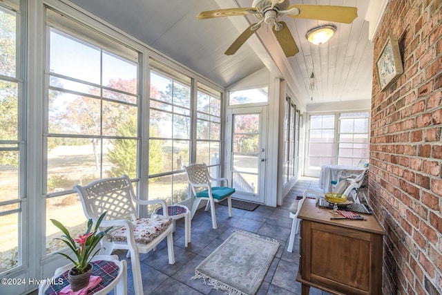 sunroom / solarium with ceiling fan and vaulted ceiling