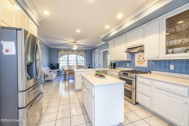 kitchen with white cabinets, stainless steel appliances, a kitchen island, and ceiling fan