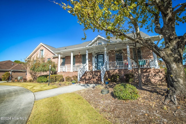 view of front of home with a front yard and covered porch