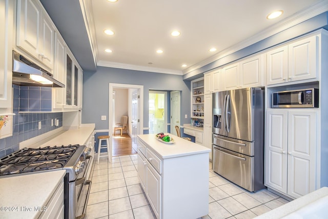 kitchen featuring decorative backsplash, appliances with stainless steel finishes, white cabinets, and light tile patterned flooring