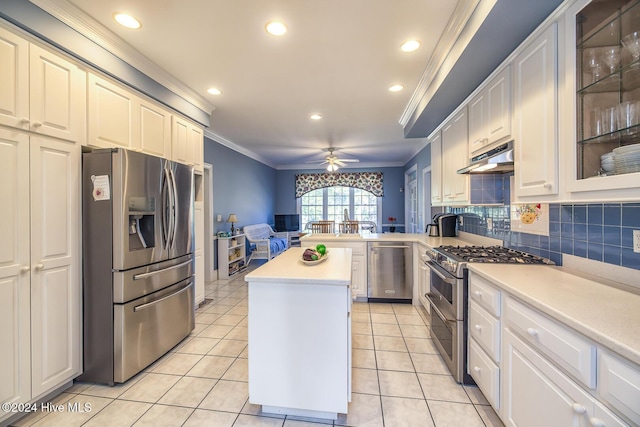 kitchen with light tile patterned floors, crown molding, stainless steel appliances, a center island, and white cabinets