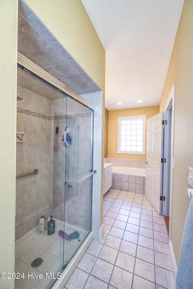 bathroom with tile patterned flooring, vanity, and separate shower and tub