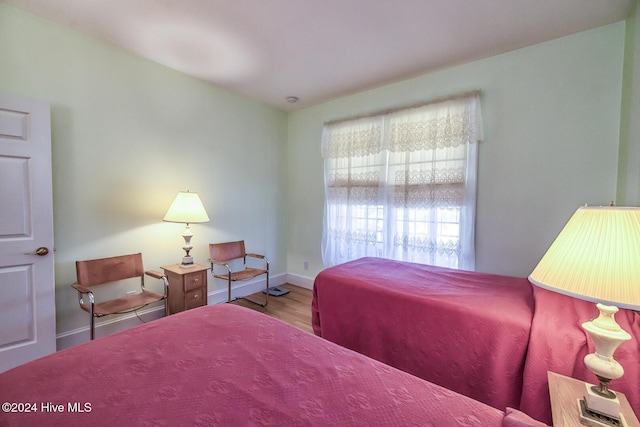 bedroom with wood-type flooring