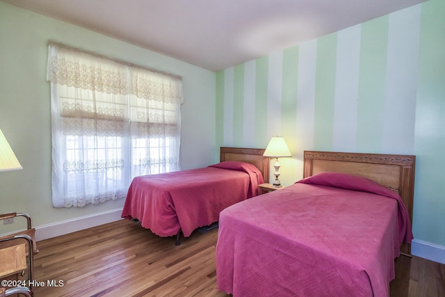 bedroom with hardwood / wood-style flooring