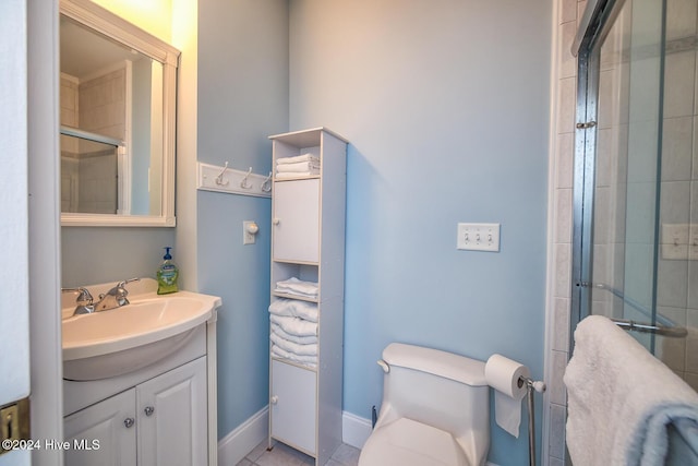 bathroom featuring an enclosed shower, vanity, toilet, and tile patterned flooring