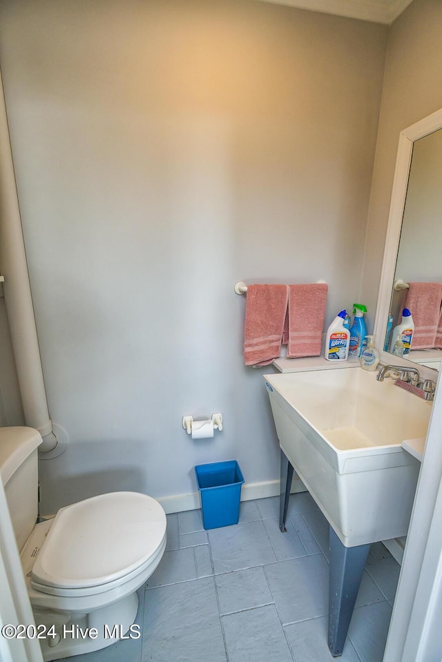 bathroom with tile patterned flooring and toilet