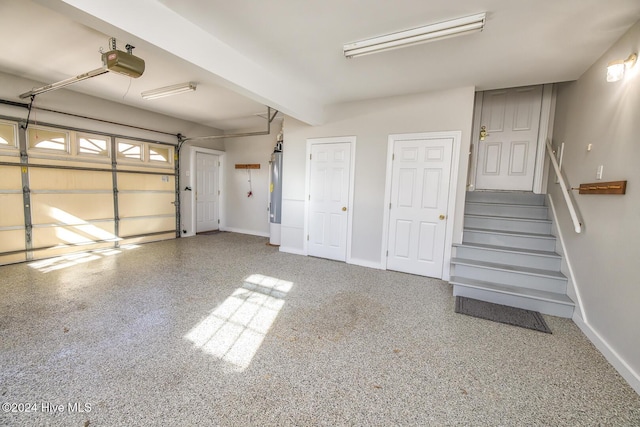 garage with a garage door opener and water heater