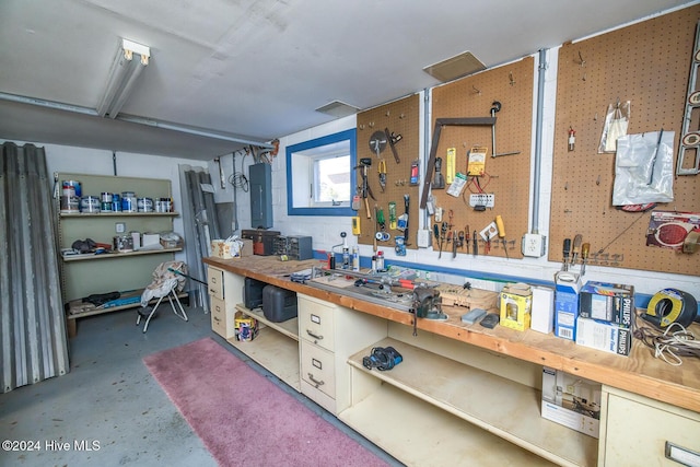 interior space with a workshop area and electric panel