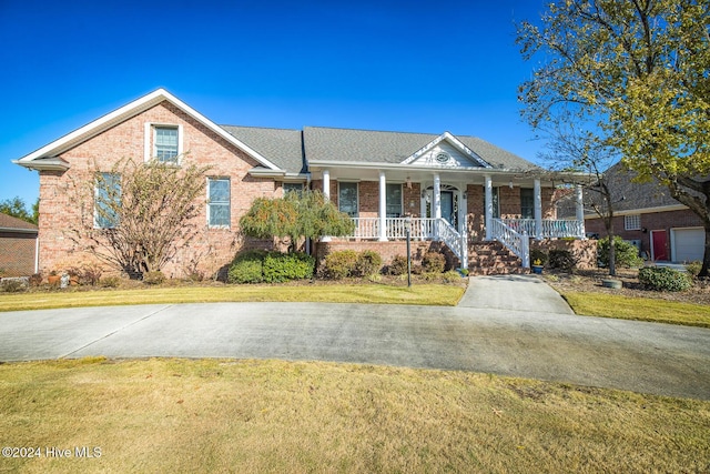 view of front of house with a porch and a front yard