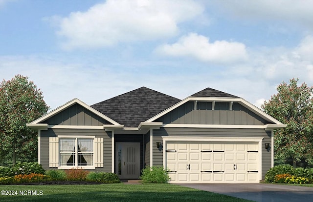 view of front of property with a garage and a front yard