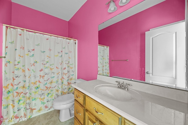 bathroom featuring curtained shower, tile patterned flooring, vanity, and toilet