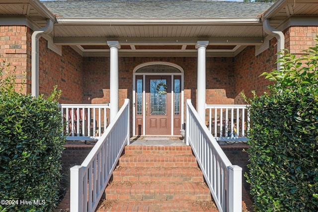 view of exterior entry with covered porch