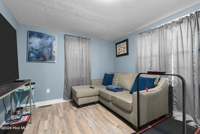 living room featuring a textured ceiling and hardwood / wood-style flooring