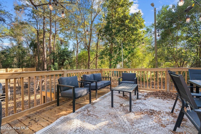 wooden terrace with outdoor lounge area