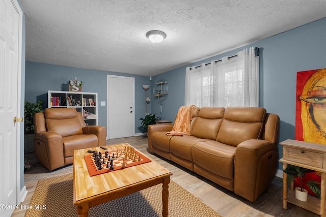 living room featuring hardwood / wood-style flooring and a textured ceiling