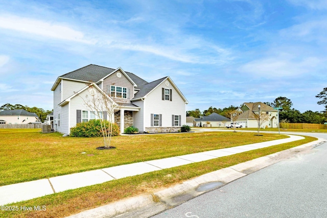 view of front of house featuring a front lawn and central air condition unit