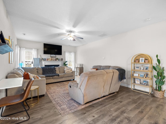 living room with ceiling fan and dark hardwood / wood-style floors