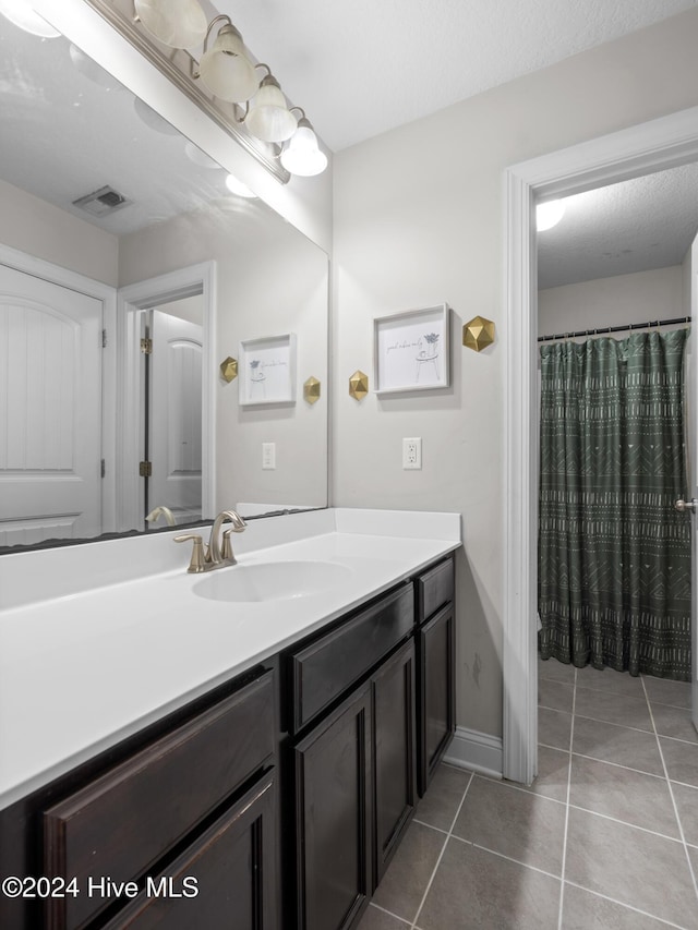 bathroom featuring vanity and tile patterned flooring