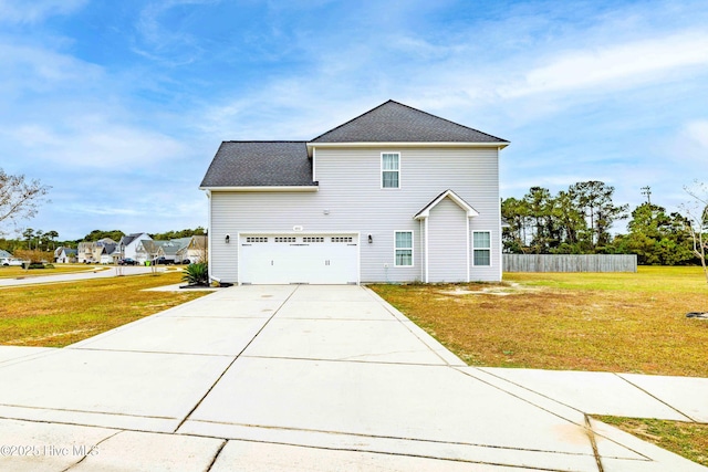 view of front of house with a front yard and a garage