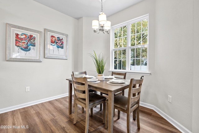 dining space with a chandelier and hardwood / wood-style flooring