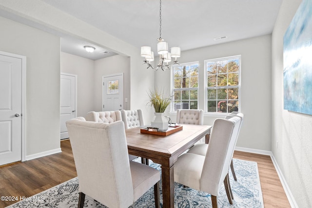 dining area with a chandelier and hardwood / wood-style flooring