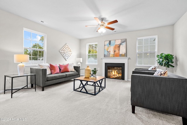 carpeted living room featuring plenty of natural light and ceiling fan