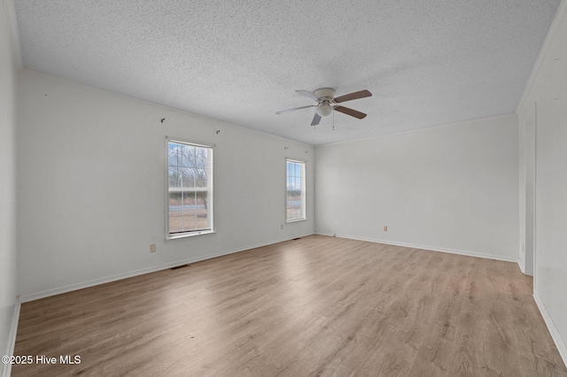 spare room with ceiling fan, light hardwood / wood-style flooring, and a textured ceiling