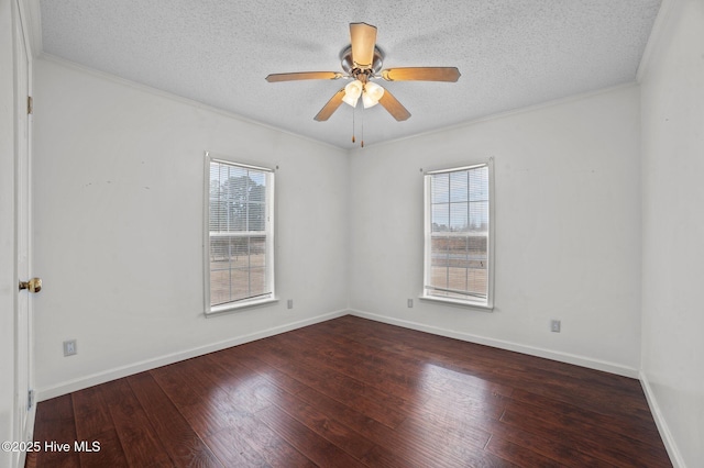 spare room featuring ceiling fan, dark hardwood / wood-style flooring, and a wealth of natural light