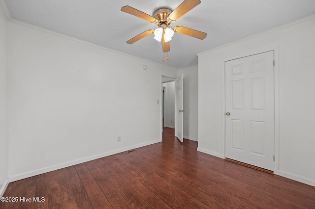 unfurnished bedroom featuring crown molding, dark hardwood / wood-style flooring, and ceiling fan