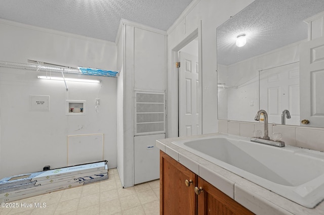 interior space with sink, washer hookup, and a textured ceiling