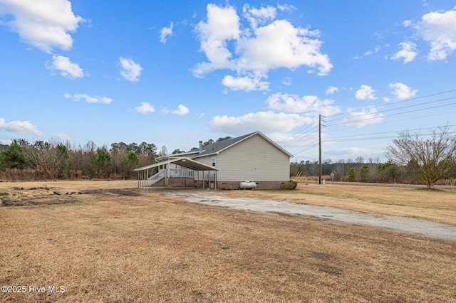 view of property exterior featuring a lawn and a carport