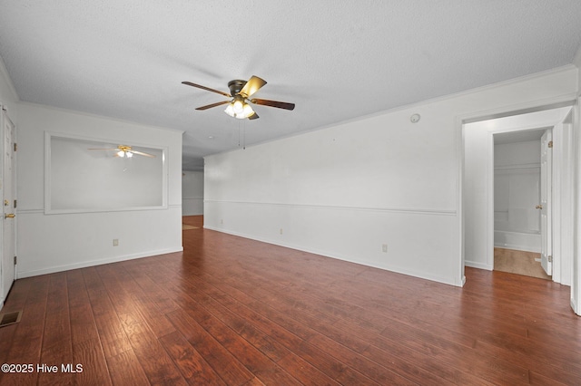 unfurnished room with crown molding, dark wood-type flooring, a textured ceiling, and ceiling fan