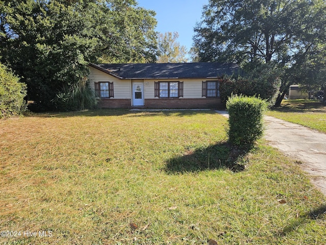 ranch-style house with a front lawn