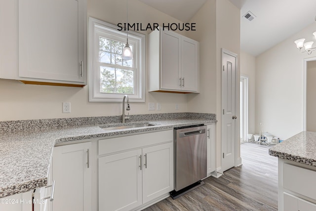 kitchen featuring dishwasher, white cabinets, hanging light fixtures, and sink