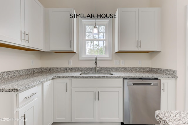 kitchen featuring white cabinetry, sink, stainless steel dishwasher, and light stone counters