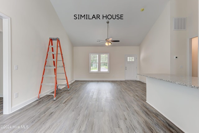 unfurnished living room featuring ceiling fan and wood-type flooring