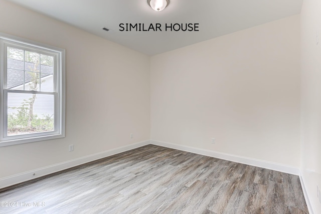 unfurnished room with light wood-type flooring