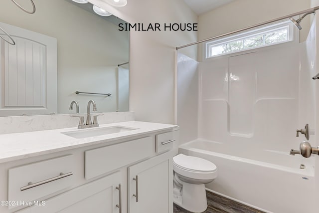 full bathroom with toilet, vanity, shower / bathtub combination, and hardwood / wood-style flooring