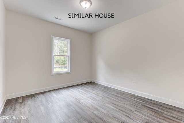 unfurnished room with hardwood / wood-style floors